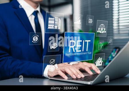 REIT, Real Estate Investment Trust Financial Concept. Geschäftsmann, der ein Notebook mit REIT-Investitionssymbolen nutzt. Immobilien, Finanzdiagramme, Wachstum, Stockfoto