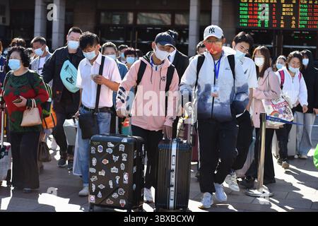 7. Oktober 2021, Peking, China: Viele Passagiere, die Gesichtsmasken trugen, um die Ausbreitung von covid-19 zu verhindern, werden als unterwegs mit Gepäck auf dem Platz vor dem Pekinger Bahnhof gesehen. Am letzten Tag des chinesischen Nationalfeiertags führte die Eisenbahn den Höhepunkt des Rückflugs von Fahrgästen, die Nationalbahn soll voraussichtlich 13,5 Millionen Passagiere und 1448 zusätzliche Personenzüge entsenden. (Kreditbild: © SheldonÂ Cooper/SOPA Bilder über ZUMA Press Wire) Stockfoto