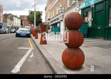 Anthony Gormley skulpturale Verkehrspoller, die 2003 in der Bellenden Road im Süden Londons installiert wurden Stockfoto