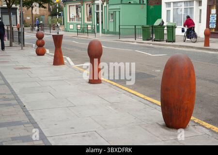 Anthony Gormley skulpturale Verkehrspoller, die 2003 in der Bellenden Road im Süden Londons installiert wurden Stockfoto