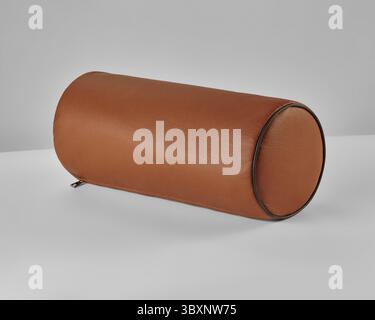 Stilvolles, zylindrisches braunes Polster-Kissen aus echtem Leder, das jedem Innenraum einen Hauch von Eleganz verleiht Stockfoto