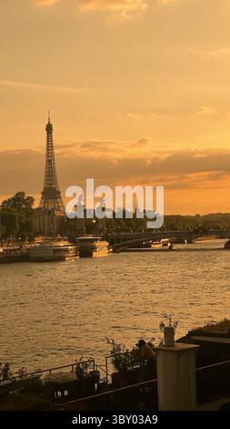 Paris Frankreich 5. Juni 2025. Atemberaubender Blick auf den Eiffelturm bei Sonnenuntergang mit einem goldenen Schein über der seine. Die Szene fängt die Ruhe ein Stockfoto