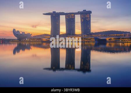 Singapur. Am frühen Morgen an der Marina Bay. Die Sonne ist hinter dem Gebäude des Hotel in Form eines Schiffes zu stehen Stockfoto