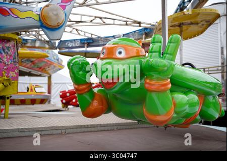 Farbenfrohe Fahrt auf dem Festgelände mit einer Figur der Teenage Mutant Ninja Turtles Stockfoto