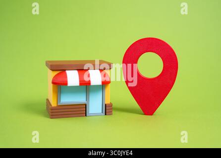 Shop und großes Symbol für die geografische Anordnung. Physischer Standort des Stores. Werbung und Kundengewinnung. Offline-Sichtbarkeit. Standort des Einzelhandelsgeschäfts Stockfoto