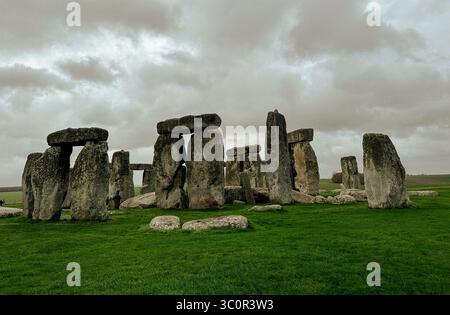 Eine dramatische Landschaft des prähistorischen Monuments Stonehenge, das sich in Wiltshire, England, befindet und unter einem dunklen und bewölkten Himmel erfasst wurde. Stockfoto