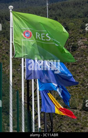 Die grüne uefa respektiert die Flagge, die neben anderen leuchtenden Flaggen auf den Fahnenmasten in andorra im Wind winkt und damit Sportlichkeit und Integrität symbolisiert Stockfoto
