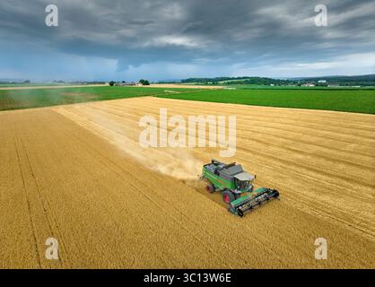 Mähdrescher ernten Weizen auf einem Feld im vertilen und fruchtbaren Langes Feld nördlich von Stuttgart, Baden-Württmberg, Deutschland Stockfoto