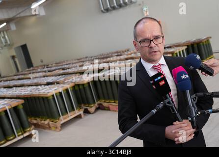22. Juli 2025, Niedersachsen, Unterlüß: Grant Hendrik Tonne (SPD), niedersächsischer Minister für Wirtschaft, Verkehr und Bau, steht vor Artilleriegeschossen im Kaliber 155 mm und beantwortet Fragen von Medienvertretern nach einem Rundgang durch die neue Munitionsfabrik der Rüstungsfirma Rheinmetall. Der Besuch des Rüstungsunternehmens ist Teil der Sommerreise des niedersächsischen Wirtschaftsministers. Foto: Marcus Brandt/dpa Stockfoto