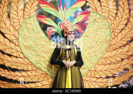 Indonesische Kulturparade in farbenfrohen, von Phoenix inspirierten Kostümen Stockfoto