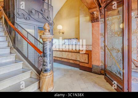 Klassisches Barcelona Wohngebäude Eingang an der Rambla Catalunya. Große Marmortreppe, Kunstvolle Schmiedeeiserne Geländer. Historischer Spanischer Architectu Stockfoto