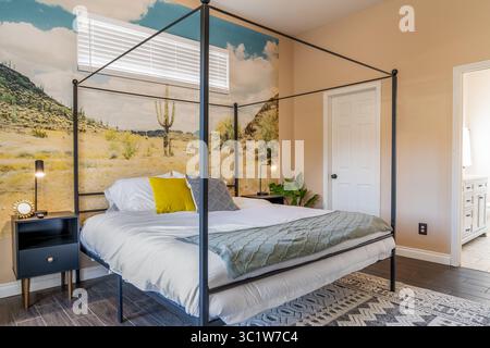 Modernes Schlafzimmer im Wüstenstil mit Bett, Kissen, Teppich, Lampen und Seitentischen Stockfoto