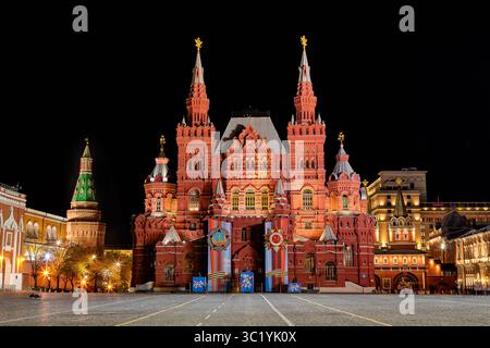 Moskau, Russland - 23. Juli 2025: Blick auf das erleuchtete staatliche historische Museum, das majestätisch auf dem Roten Platz steht, dessen rote Fassade sich vom dunklen Nachthimmel abhebt. Stockfoto