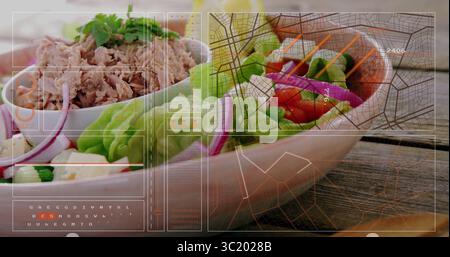 Zeigt eine Schüssel mit geriebenem Thunfischsalat auf dem Tisch, mit Gemüse- und Tomatenspießen, grafischer Überlagerung Stockfoto