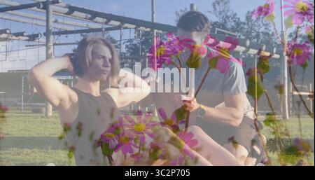 Sportbekleidung im Park mit Mattenstangen-Smartwatch und Daisy-Overlay. Fitness, Outdoor, Training, Gesundheit, Motivation, w Stockfoto