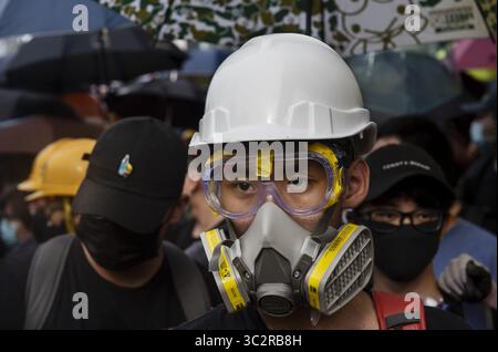 Juli 2019, Hongkong, China: Anti-Regierungs-Demonstranten, die während der Demonstration mit Gasmasken und Regenschirmen ausgestattet wurden, um sich vor dem möglichen Gebrauch von Tränengas und Pfefferspray durch den Polizisten zu schützen. Tausende Demonstranten setzen ihren wöchentlichen Anti-Regierungs-Protest fort und fordern die Regierung auf, das Auslieferungsgesetz vollständig zurückzuziehen und eine unabhängige kommission einzurichten, die die Probleme der Polizei mit unverhältnismäßiger Gewalt gegen Demonstranten untersucht Der Protest fand im Bezirk Yuen Long statt Stockfoto