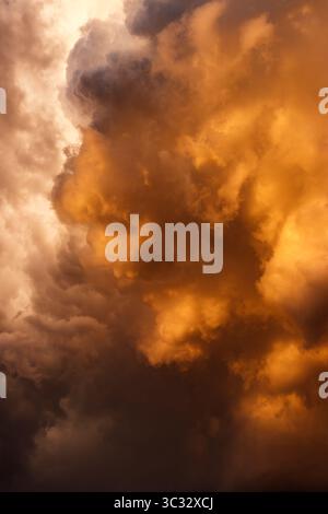 Wolkenlandschaft im dramatischen Himmel. Extremes Wetter. Dunkelgoldene Sturmwolke mit aufragendem Cumulonimbus Stockfoto