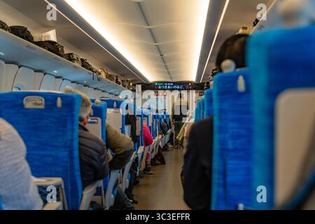 Tokio, Japan - 15. Januar 2025 Innenraum des modernen Shinkansen-Hochgeschwindigkeitszugs mit Passagieren auf Sitzen. Stockfoto