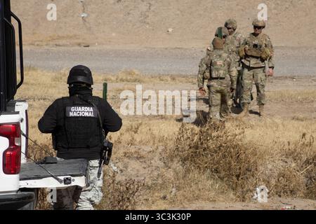 Guardia Nacional und Militärangehörige diskutieren Strategien in einem Feld in der Nähe von Ciudad Juarez, einem Hotspot für Grenzübergänge und Einwanderungsfragen. Stockfoto
