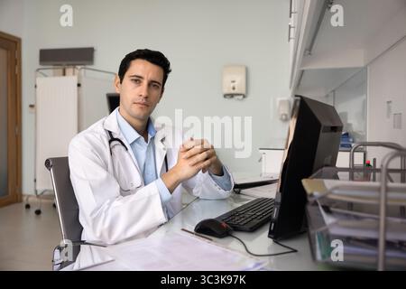 Selbstbewusster, gutaussehender junger Latein-Doktor-Mann posiert für ein Porträt Stockfoto