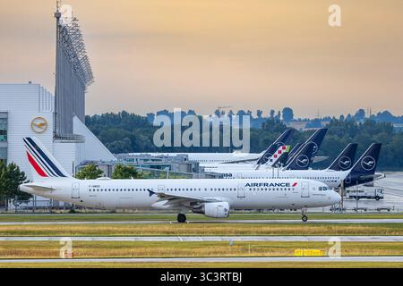 Abendlicher Flugbetrieb auf Start- und Landebahn des Münchner Flughafens, Oberding, 15.07.2025 ein Airbus A321-100 der Fluggesellschaft Air France mit der Registrierung F-GMZD und dem Taufnamen Toulon rollt am Flughafen München auf dem Vorfeld. Im Hintergrund ist das Terminal 2 zu sehen, an dem hauptsächlich Lufthansa und Partner der Star Alliance abgefertigt werden. Air France ist Mitglied der Luftfahrtallianz SkyTeam. Von München aus verbinden Air France die bayerische Landeshauptstadt primär mit Paris-Charles-de-Gaulle, wo Umsteigeverbindungen zu weltweiten Zielen wie New York, Tokio, Joh Stockfoto