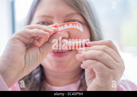 Porträt glückliche reife Frau lächelnd, die perfekte weiße Zähne zeigt, Zahnhalteapparate, Zahngesundheit, positives Altern, Selbstvertrauen, natürliche Schönheit, lange Zeit Stockfoto