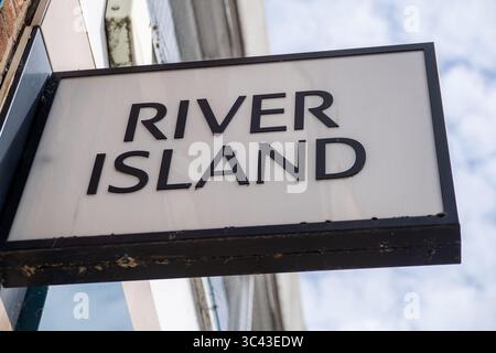 Windsor, Berkshire, Großbritannien. Juli 2025. Dem Vernehmen nach besteht die Gefahr eines Zusammenbruchs der High Street Modekette River Island aufgrund sinkender Verkäufe und schwieriger Handelsbedingungen. „Die Vermieter, die den Rettungsplan von River Island unterstützen, sind auf erhebliche Mietsenkungen ausgerichtet, wobei einige im Rahmen einer Umstrukturierung, die von der Gründerfamilie Lewis geleitet wurde, Kürzungen von bis zu 100 % drohen. Der Plan der umstrittenen Modekette wird 33 Geschäfte schließen und bei 71 anderen Mietsenkungen anstreben, wobei einige Vermieter eine Reduzierung von 25 % oder 40 % erwarten, während einige davon möglicherweise überhaupt keine Miete erhalten. Die Lewis-Familie, durch ihre Investoren Stockfoto
