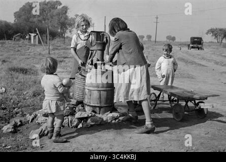 Juni 2018 - Kalifornien, USA - Kinder von Wanderarbeitern, die Wasser holen, American River Migrant Camp, San Joaquin Valley, Kalifornien, USA, Dorothea lange, Farm Security Administration, November 1936 (Kreditbild: © JT Vintage/Glasshouse Via ZUMA Wire) Stockfoto
