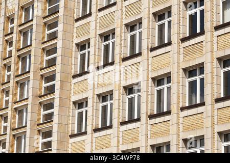 Altes Backsteinhaus. Symmetrische Fensteranordnung. Klassische urbane Architektur. Europäischer Wohnblock. Fassade im traditionellen Stil. Stockfoto
