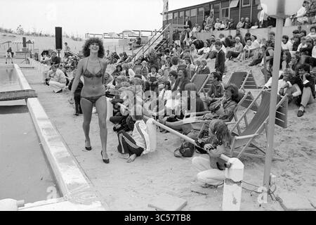 Miss Beach Election Zandvoort II, Miss Election, Zandvoort, Zandvoort, 08-08-1981 Whizgle News, Dutch Desk, Niederlande, 1950-2000 Eine Gruppe von Zuschauern versammelt sich am Pool und beobachtet mit Interesse, wie eine Frau selbstbewusst in einem Bikini hockt und den Geist des Sommers und der Freizeit verkörpert. Familien und Freunde sitzen auf Liegestühlen, fasziniert von der lebhaften Atmosphäre. Stockfoto