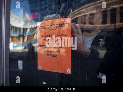 15. März 2020, Chicago, IL, USA: Rey Guzman hängt am Sonntag, den 15. März 2020, ein Schild in der Emporium Bar im West Loop, kurz nachdem Gouverneur von Illinois, J. B. Pritzker, bekannt gegeben hatte, dass ab Montag alle Bars und Restaurants in der Nähe von Dining-in-Kunden sein würden. (Kreditbild: © TNS via ZUMA Wire) Stockfoto