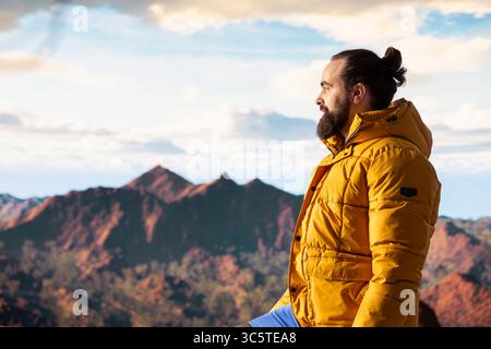 Der Wanderer stellt sich der Herausforderung, durch die Wildnis zu wandern, und genießt die Panorama-Berglandschaft als Erinnerung an Kraft und die Belohnung von Outdoor-Abenteuern. Abenteuerlustige. Stockfoto