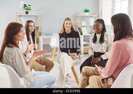 Verschiedene Frauen bilden einen Gesprächskreis, freuen sich auf unterstützende Gruppendiskussionen, Sprechen, Gesten Stockfoto