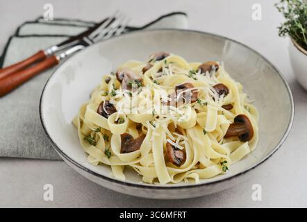 Pilznudeln mit Parmesankäse und Thymian auf leichtem Hintergrund Stockfoto
