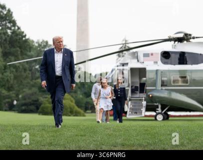 Präsident Donald Trump geht seiner Familie voraus, nachdem er Marine One auf dem Südrasen des Weißen Hauses verlassen hat, wobei das Washington Monument im Hintergrund sichtbar ist. Washington, D.C. 29. Juli 2025. Bild mit freundlicher Genehmigung des Weißen Hauses. Stockfoto