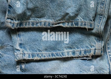 Gefaltete Damenjeans mit Falten und Nähten am unteren Teil der Hose als Hintergrund für Design und Mode aus nächster Nähe Stockfoto