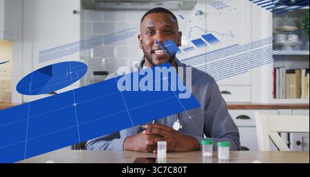 Ein lächelnder Arzt sitzt am Küchentisch und überprüft Datendiagramme mit Stethoskop und Probenröhrchen Stockfoto