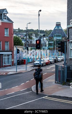 25. Juli 2025 Cork, Irland eine urbane Straßenszene mit Verkehrslichtern kombiniert mit einem lebendigen Graffiti-Hintergrund Stockfoto