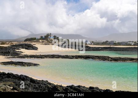 Türkisfarbenes Wasser und vulkanische Felsen im Dorf El Cotillo, am Strand La Concha, Fuerteventura Stockfoto