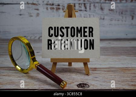 Text zur Kundenbindung auf Papier mit Lupe geschrieben Stockfoto