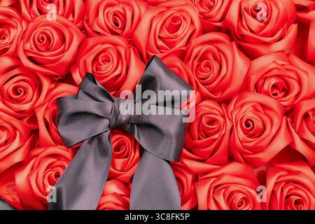 Ein Trauerstrauß aus roten Rosen mit schwarzem Bogen liegt als Opfergabe auf der Gasse der Erinnerung, ein Symbol der Trauer, der Erinnerung und des Respekts für die gefallenen Helden Stockfoto