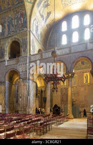 Innenansicht des Markusdoms (Basilika di San Marco), Venedig, Italien, mit Mosaiken, Bögen, Marmorwände und Kronleuchter in byzantinischem Archit Stockfoto