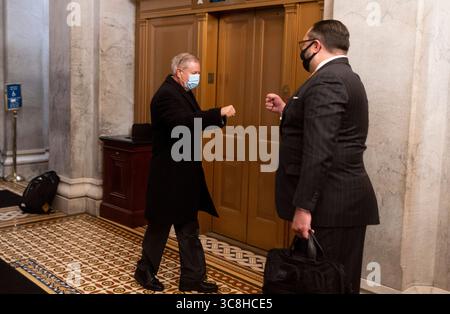 12. Februar 2021, Washington, District of Columbia, USA: USA - 12. FEBRUAR: Senator Lindsey Graham, R-S.C., links, gibt Jason Miller, Senior Adviser der Trump-Wiederwahl-Kampagne 2020, vor Beginn des Amtsenthebungsverfahrens im Senat am Freitag, den 12. Februar 2021 eine Faustwelle (Credit Image: © Bill Clark - Pool via CNP/CNP via ZUMA Wire) Stockfoto
