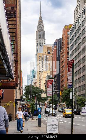 New Yorker gehen entlang der Fifth Avenue, New York City, mit dem Chrysler Building im Hintergrund, Stadtleben, Straßenfotografie, Manhattan-Szene Stockfoto