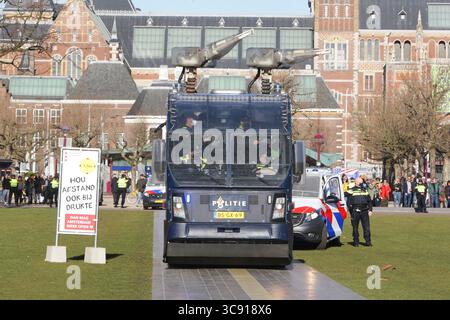 28. Februar 2021, Amsterdam, Niederlande: Niederländische Anti-Aufstand-Polizisten Wasserkanonen-Fahrzeugteam nehmen während der illegalen Demonstration gegen die Coronavirus-Maßnahmen am 28. Februar 2021 in Amsterdam, Niederlande, Stellung in der Nähe von Anti-Lockdown-Unterstützern. Die Amsterdamer Bürgermeisterin Femke Halsema stufte den Museumplein als "Sicherheitsrisikobereich" ein und gab Polizeibeamten das Recht, jeden in diesem Bereich zu überprüfen und zu durchsuchen, um illegale Demonstrationen und Vandalismus zu verhindern. (Kreditbild: © Paulo Amorim/VW Pics via ZUMA Wire) Stockfoto