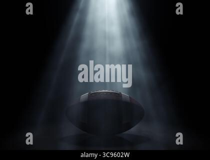 Ein american Football-Sportball, der von einem einzigen ätherischen Licht auf einem dunkelschwarzen Hintergrund beleuchtet wird – 3D-Rendering Stockfoto