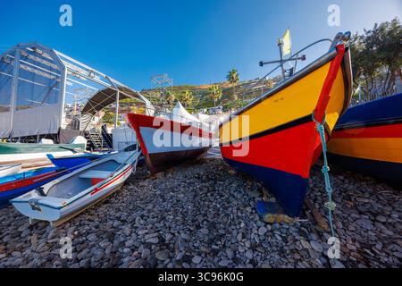 Bunt bemalte portugiesische Boote am Kiesstrand der Insel Madeira. Hochwertige Fotos Stockfoto