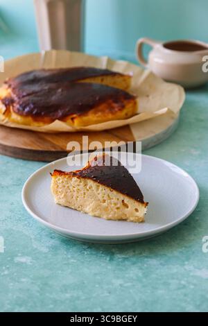 Scheibe baskischer Käsekuchen mit karamelisierter Oberseite auf Platte Stockfoto