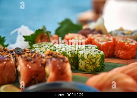 Eine lebendige Auswahl an Sushi-Köstlichkeiten mit frischen Zutaten und künstlerischer Präsentation in einer Küstenlandschaft Stockfoto