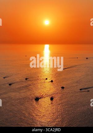 Aktau. August 2025. Eine Drohnenaufnahme vom 5. August 2025 zeigt einen Sonnenuntergang über dem Kaspischen Meer in Aktau, Kasachstan. Menschen genießen oft einen wunderschönen Blick auf den Sonnenuntergang über das Kaspische Meer in der kasachischen Hafenstadt Aktau. Quelle: Li Renzi/Xinhua/Alamy Live News Stockfoto